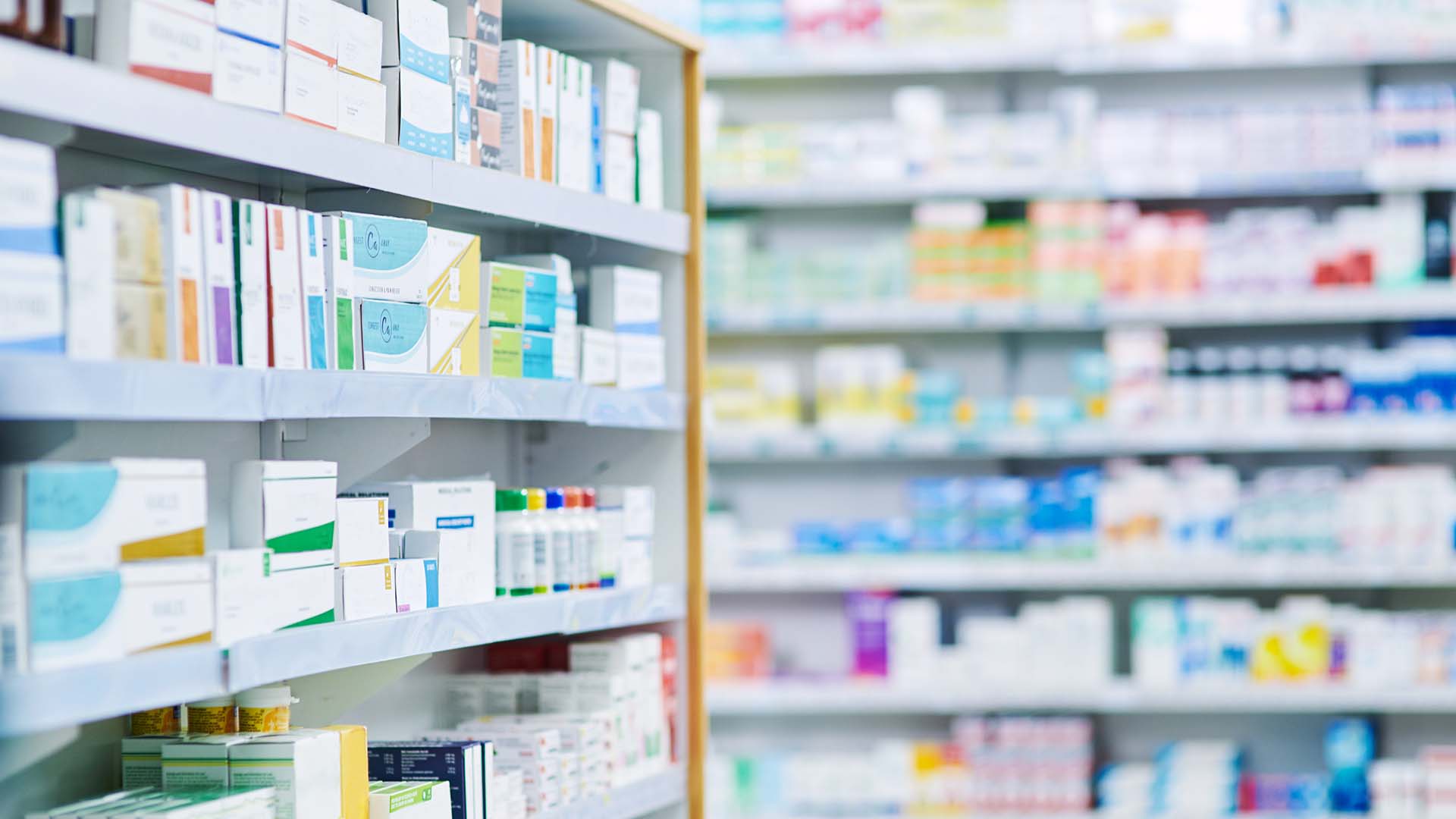 Image of pills next to a medicine bottle